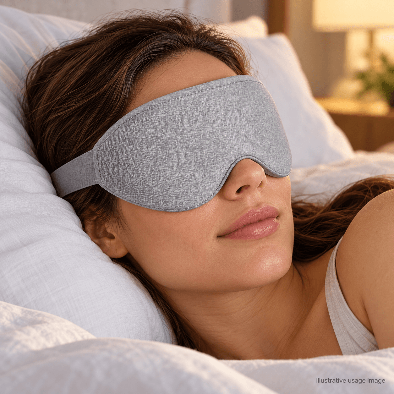 Illustrative scene of an adult resting while wearing a gray contoured sleep mask